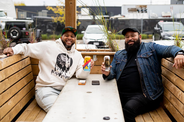 Two black brewery owners share their created beers with each other.