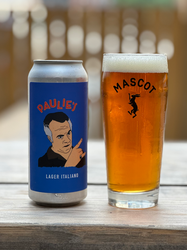 Can of Paulie's Italian lager by Mascot Brewery next to a filled up, Mascot branded beer glass.