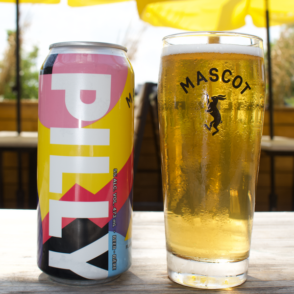 Can of Mascot's Pilly craft beer next to a chilled, Mascot branded beer glass